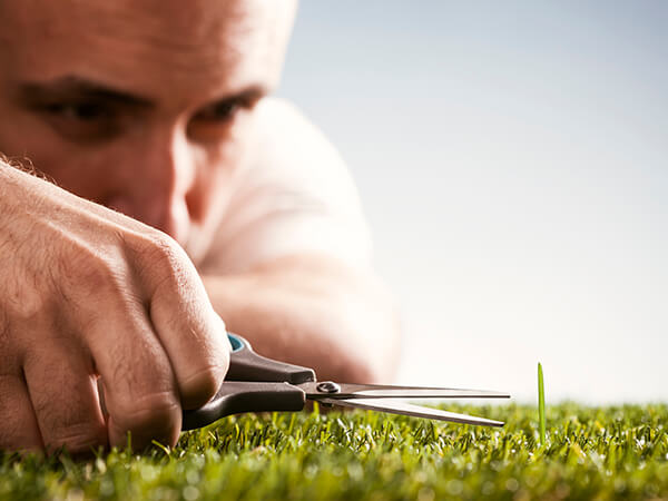 erp implementation detail 01 man cutting grass with scissors