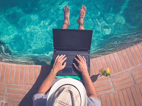 ERP Software on a laptop by a pool